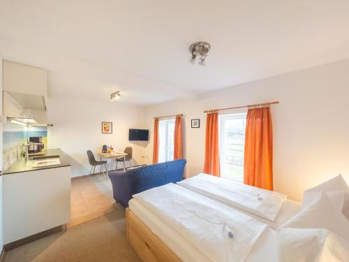 a bedroom with a large bed and a table at Gut Vorwerk in Sagard