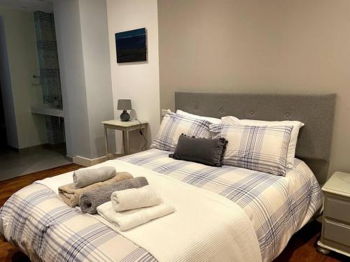 a bedroom with a large bed with towels on it at Stylish 2BR contemporary design perfect vacation in Gibraltar