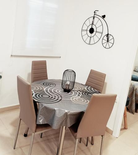 a dining room table with a black and white table cloth at Tarancon Suite Exclusivo in Tarancón
