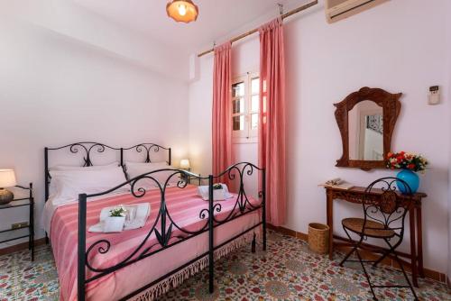 ein Schlafzimmer mit einem Bett, einem Tisch und einem Spiegel in der Unterkunft Villa Al Faro San Vito in San Vito lo Capo