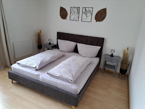a bed with two pillows on it in a bedroom at Casa Sandra in Villach