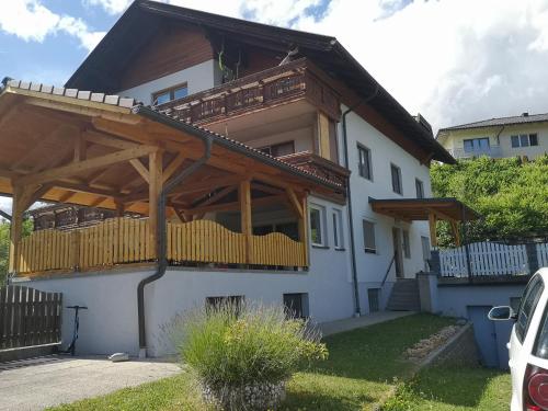 a house with a wooden pergola on top of it at Casa Sandra in Villach
