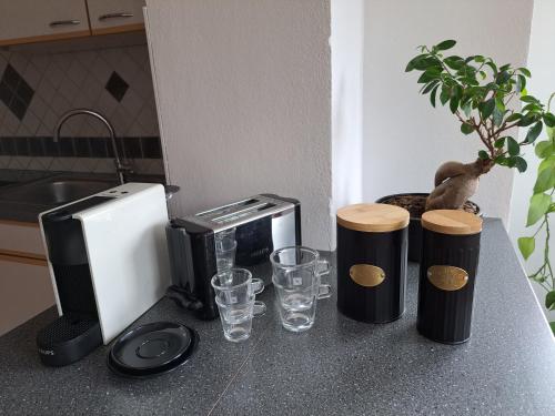 a kitchen counter with a counter top with drinking glasses at Casa Sandra in Villach