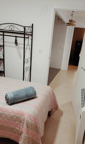 a bed with a blue pillow on top of it at Tarancon Suite Exclusivo in Tarancón