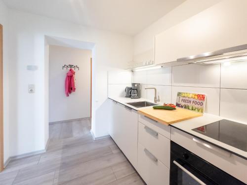 a kitchen with white cabinets and a counter top at Gut Vorwerk in Sagard