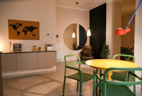 a living room with a yellow table and chairs at Casa Ferretti apartment in Brindisi