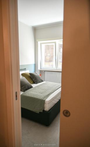 a bedroom with a bed and a window at Casa Ferretti apartment in Brindisi