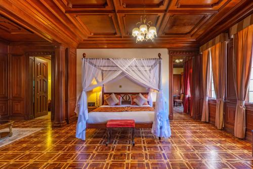 a bedroom with a bed with a canopy at Muthu Sovereign Suites & Spa, Limuru Road, Nairobi in Limuru