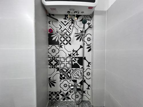 a bathroom with a black and white patterned wall at Little Japan Room 301-Ben Thanh market-D1 in Ho Chi Minh City