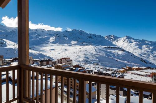 a view from a balcony with snow covered mountains at Hôtel Koh-I Nor by Les Etincelles in Val Thorens