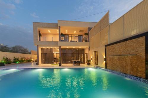 a house with a swimming pool in front of it at Adam's Luxury Villa DeadSea in Sowayma