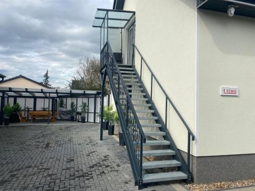 a staircase leading up to a building with a door at FEWO Salzwedel, Zum Dorfplatz in Salzwedel