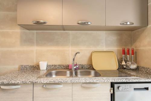 a kitchen with a sink and a counter top at Lovely Appartement Prestigia Hayriad in Rabat