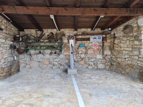 a room with a parking meter in a stone wall at Villa Goga in Martinšćica