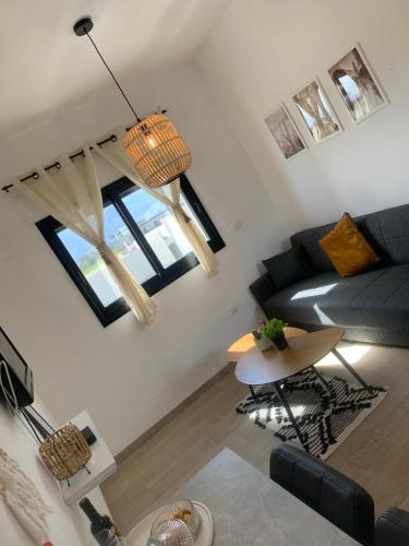 a living room with a couch and a table at צימר יערת הדבש in Hagoshrim