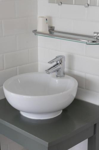 a white sink on a counter in a bathroom at Hotel de la Bourse in Maastricht