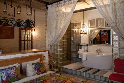 a bathroom with a bath tub and a sink at MaNNa Boutique Hotel in Kyiv