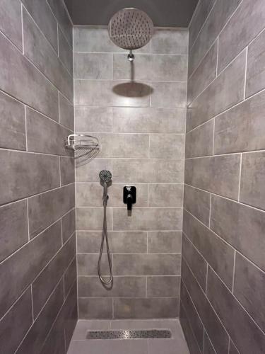 a shower with a shower head in a bathroom at Готельно-ресторанний комплекс Щастя in Poltava