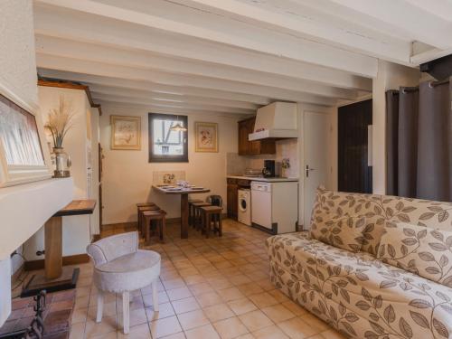 a living room with a couch and a kitchen at Holiday Home Le Clos du Golf-2 by Interhome in Cabourg