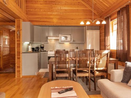 a kitchen and dining room with a table and chairs at Holiday Home Mervinrinne by Interhome in Luosto