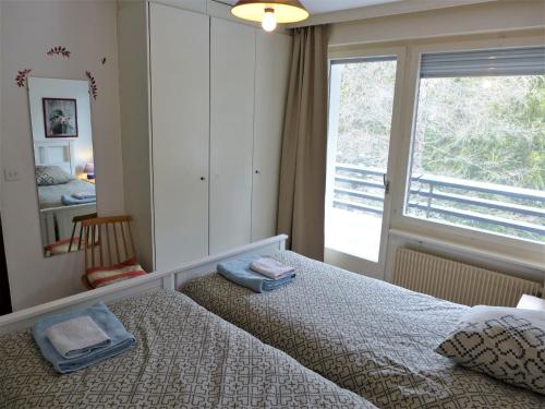 a bedroom with a bed and a large window at Apartment Cransalpin Apt- 11 - Secteur 1 by Interhome in Vermala