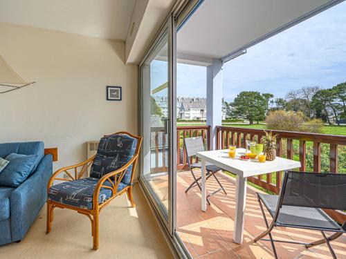 a living room with a table and chairs on a balcony at Apartment Plein Ciel-1 by Interhome in Carnac-Plage