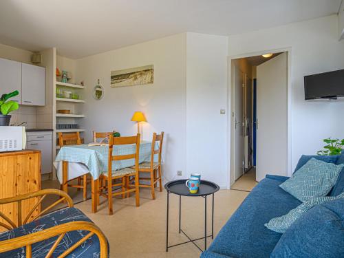 a living room with a blue couch and a table at Apartment Plein Ciel-1 by Interhome in Carnac-Plage