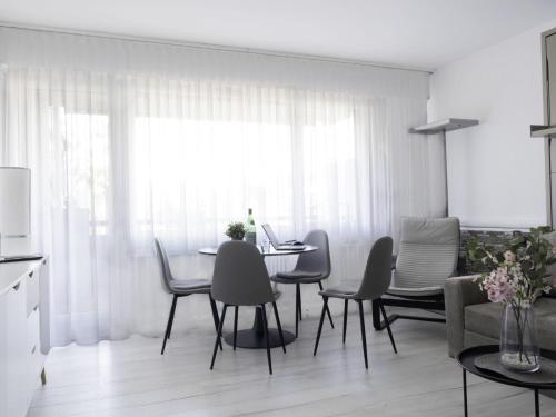 a dining room with a table and chairs at Apartment Lakeview App- 214 by Interhome in Bissone