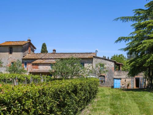 an old stone house with a garden and trees at Apartment Fattoria Petraglia - Terrazza by Interhome in Monteriggioni