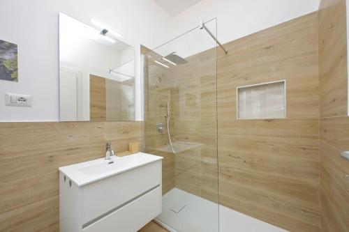 a bathroom with a white sink and a shower at Aurelia Antica Terrace Apartment in Rome