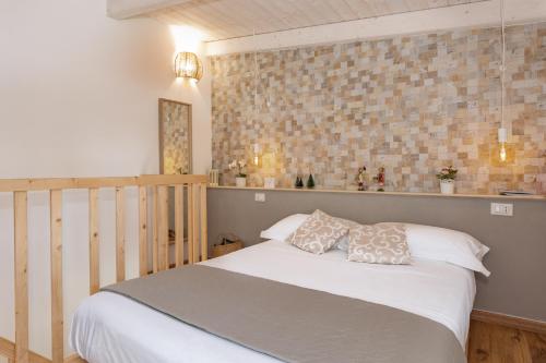 a bedroom with a white bed with two pillows at Loft 35 - private parking in Quartu SantʼElena