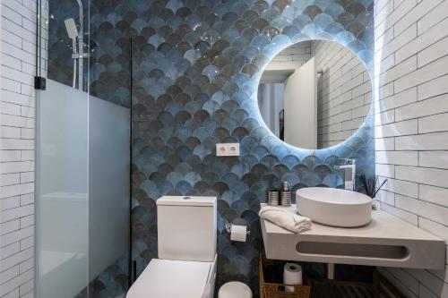 a bathroom with a sink and a mirror at Vip Apartments Valencia in Valencia