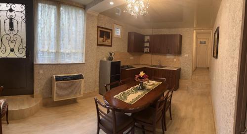 a kitchen and dining room with a table and chairs at Kutaisi City Heart Apartment in Kutaisi