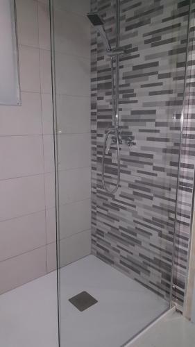 a shower with a glass door in a bathroom at luxmar beach in Benidorm