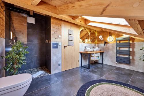 a bathroom with a toilet and a wooden ceiling at Chalet Alpi in Garmisch-Partenkirchen