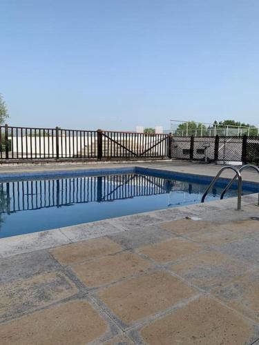 a swimming pool with a fence and a metal railing at Casa da Oliveira in Nelas