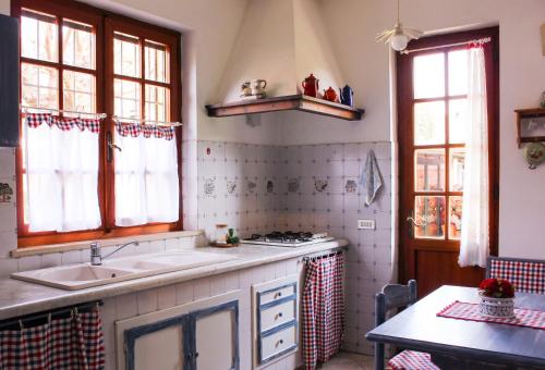 a kitchen with a sink and a stove at "Lilla" in Calci