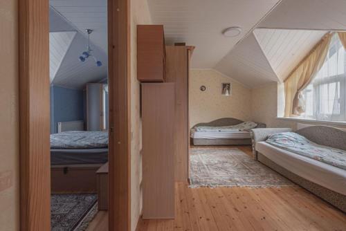 Habitación pequeña con 2 camas y ventana en House Perkūno al 59B, en Kaunas