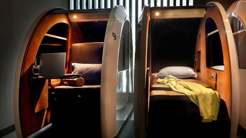 a small room with a bunk bed and a laptop at sleep 'n fly Sleep Lounge, A-Gates Terminal 3 - TRANSIT ONLY in Dubai