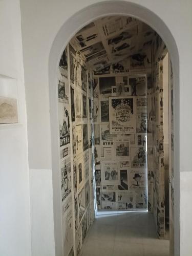 a hallway with a wall covered in posters at Can ventura in Deltebre