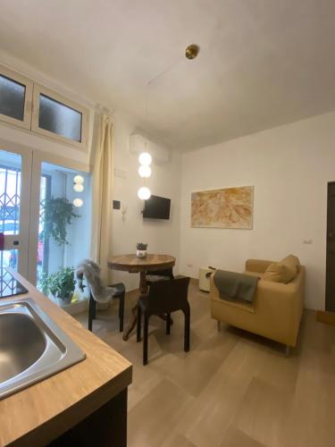 uma cozinha e sala de estar com um sofá e uma mesa em Duca apartment em Perugia
