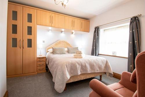 a bedroom with a bed and a window at Y Beudy, Converted Former Dairy in Conwy