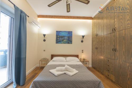 a bedroom with a bed with two white towels on it at Kalista apartment Airport by Airstay in Spata