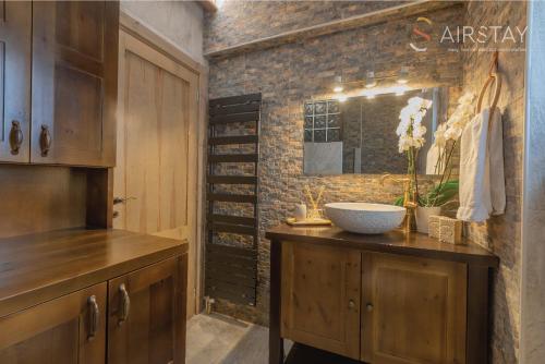 a bathroom with a sink and a brick wall at Kalista apartment Airport by Airstay in Spata