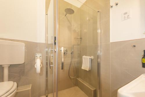 a bathroom with a glass shower with a toilet at Hotel City Center in Palermo
