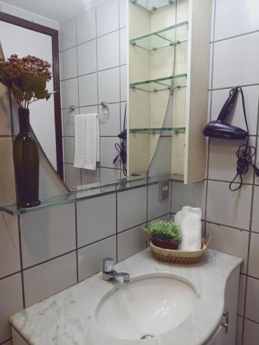 a bathroom with a sink and a mirror at BOA VIAGEM 2 quartos 100 m da praia até 5 pessoas in Recife