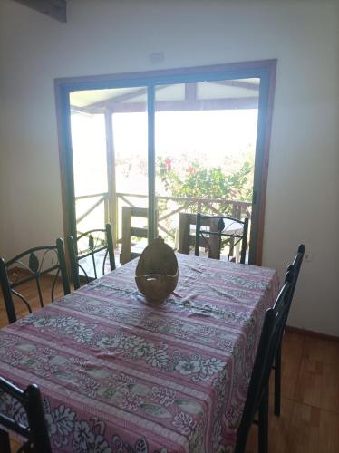 a dining room table with a bowl on top of it at Cabañas MANA NUI INN in Hanga Roa