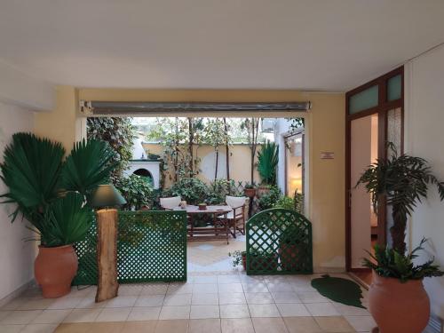 a patio with a table and chairs and potted plants at Studio Apollonia in Alexandroupoli