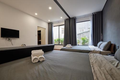 a hotel room with two beds and a large window at The Garden Capsule Hotel in Danang