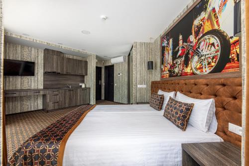 a hotel room with a bed and a tv at Resort Hotel Elija in Šventoji
